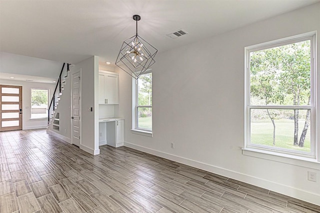 141 Awehi Ln, Bastrop, TX 78602 - unfurnished room featuring baseboards, recessed lighting, a chandelier, light wood finished floors, and stairs