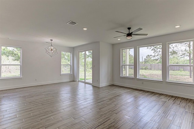 141 Awehi Ln, Bastrop, TX 78602 - spare room with healthy amount of natural light, baseboards, wood finished floors, a chandelier, and recessed lighting