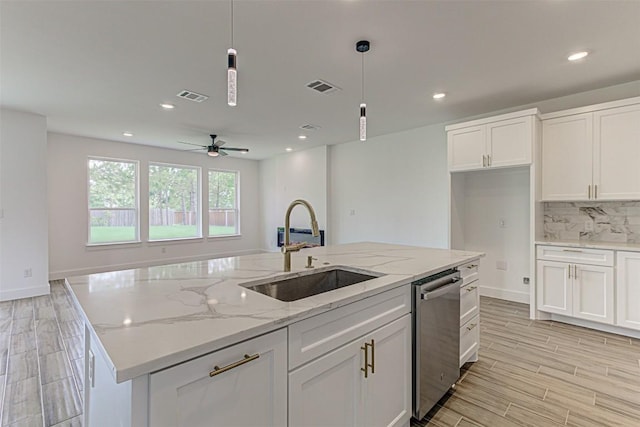 141 Awehi Ln, Bastrop, TX 78602 - kitchen featuring a sink, stainless steel dishwasher, white cabinetry, pendant lighting, and recessed lighting