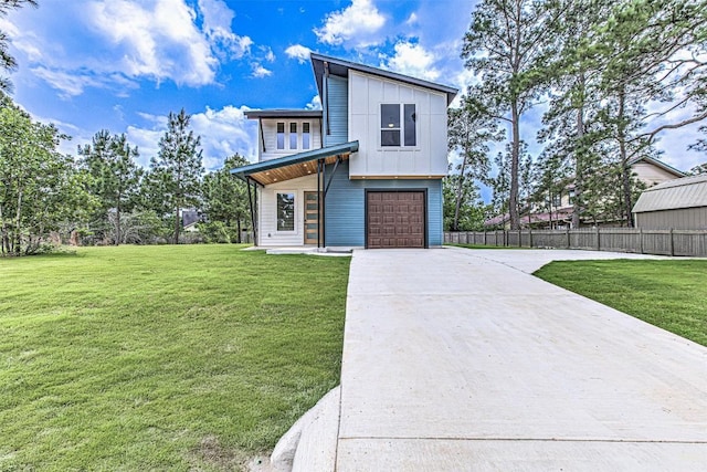 141 Awehi Ln, Bastrop, TX 78602 - contemporary house with concrete driveway, an attached garage, and board and batten siding