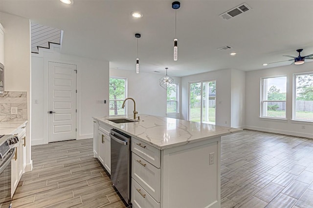 141 Awehi Ln, Bastrop, TX 78602 - kitchen with a sink, stainless steel appliances, wood finish floors, healthy amount of natural light, and recessed lighting