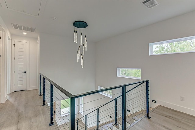 141 Awehi Ln, Bastrop, TX 78602 - stairs with attic access, wood finished floors, and baseboards