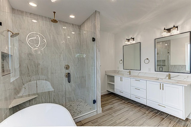 141 Awehi Ln, Bastrop, TX 78602 - bathroom with a stall shower, a soaking tub, double vanity, recessed lighting, and wood tiled floors