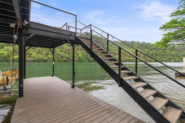 dock area with stairway and a water view