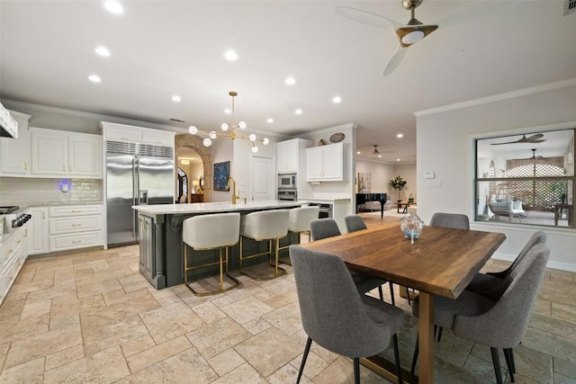 dining area with crown molding, a ceiling fan, stone tile floors, and recessed lighting
