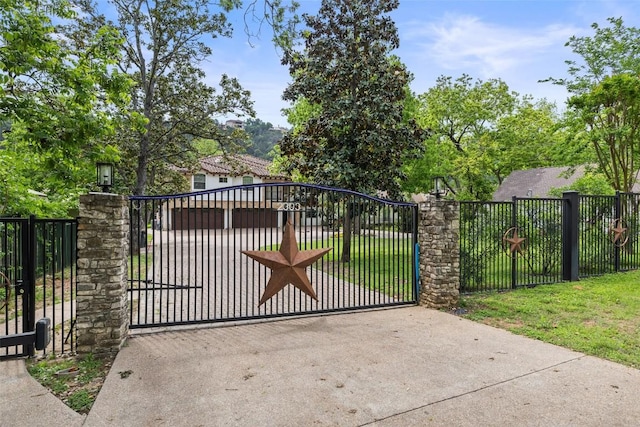 view of gate with a yard and fence