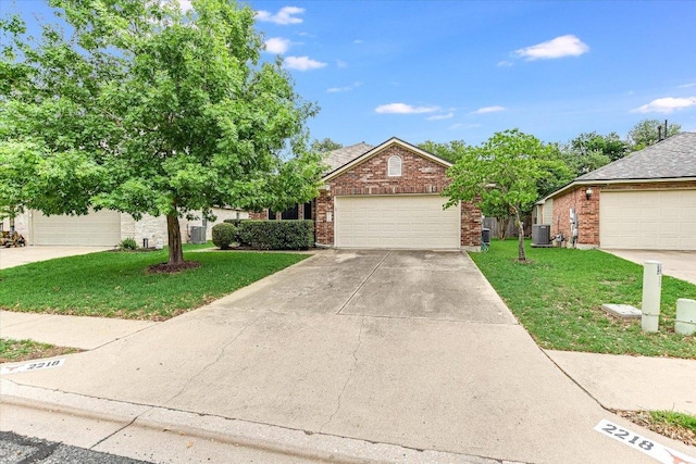 view of front facade featuring concrete driveway, cooling unit, brick siding, and a front yard