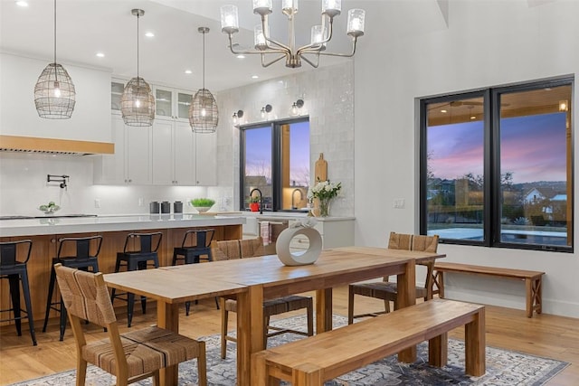 dining room featuring recessed lighting, a notable chandelier, and light wood finished floors