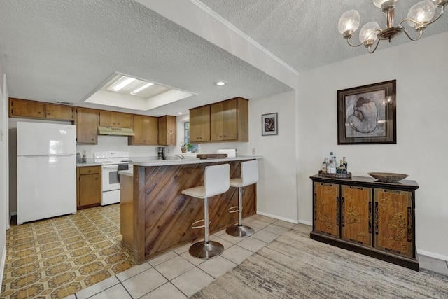 1871 Patty Dr, Canyon Lake, TX 78133 - kitchen with white appliances, under cabinet range hood, a textured ceiling, brown cabinetry, and a chandelier