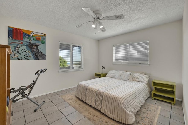 1871 Patty Dr, Canyon Lake, TX 78133 - bedroom featuring light tile patterned floors, a textured ceiling, and a ceiling fan