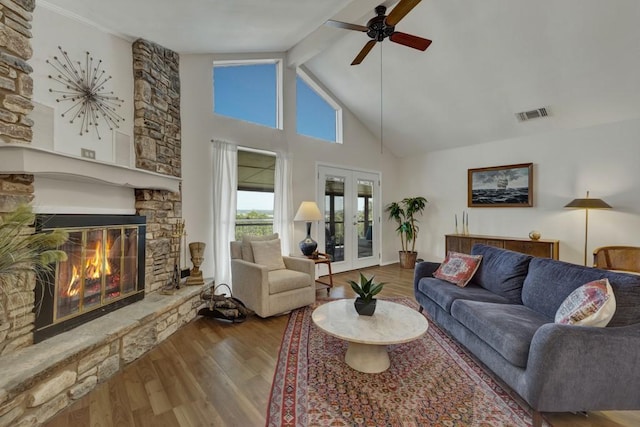 1871 Patty Dr, Canyon Lake, TX 78133 - living area featuring wood finished floors, ceiling fan, a fireplace, beam ceiling, and french doors