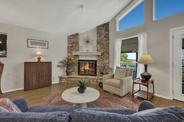 1871 Patty Dr, Canyon Lake, TX 78133 - living area featuring wood finished floors, high vaulted ceiling, and a fireplace