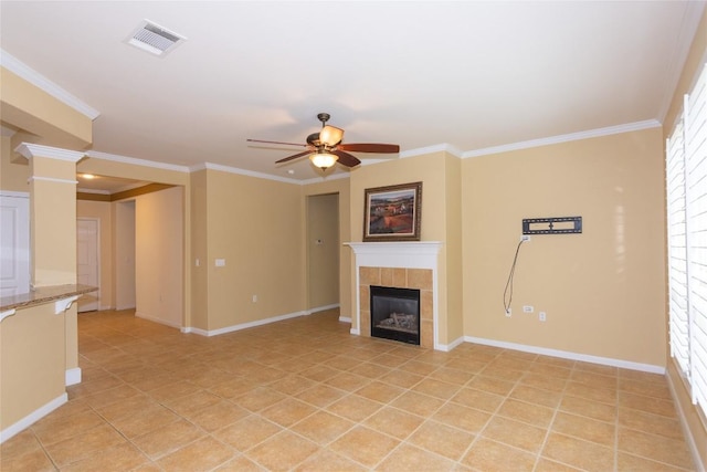 unfurnished living room with visible vents, baseboards, ceiling fan, and a fireplace