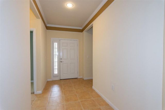 foyer entrance with baseboards, ornamental molding, and light tile patterned floors
