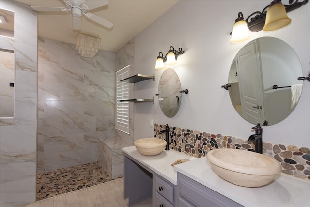 full bath with double vanity, a sink, walk in shower, and ceiling fan
