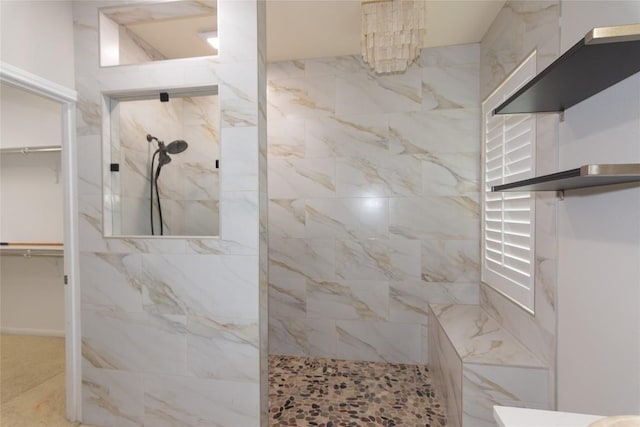 full bath with walk in shower and a spacious closet
