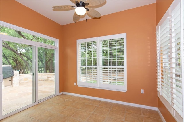 spare room featuring baseboards, ceiling fan, and light tile patterned flooring