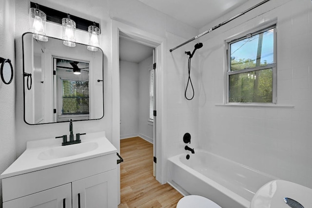 bathroom with vanity, ceiling fan, wood finished floors, and tub / shower combination