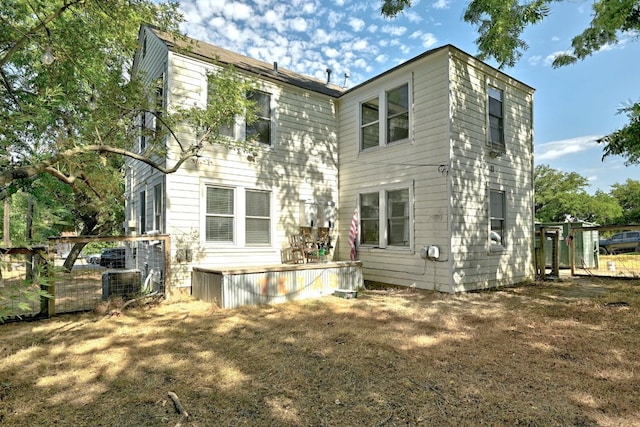 rear view of house with cooling unit