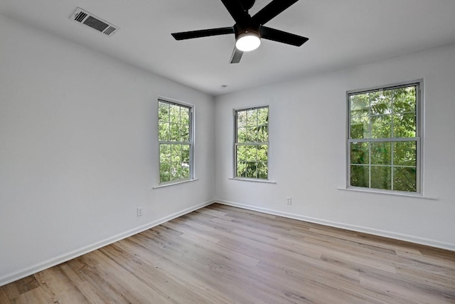 unfurnished room featuring baseboards, visible vents, and light wood-type flooring