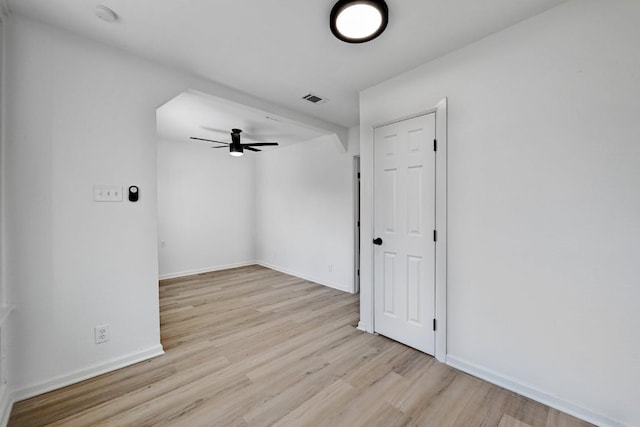 unfurnished room featuring baseboards, ceiling fan, visible vents, and wood finished floors