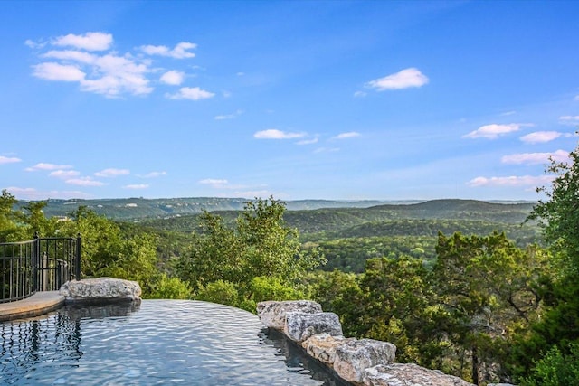 property view of mountains featuring a wooded view