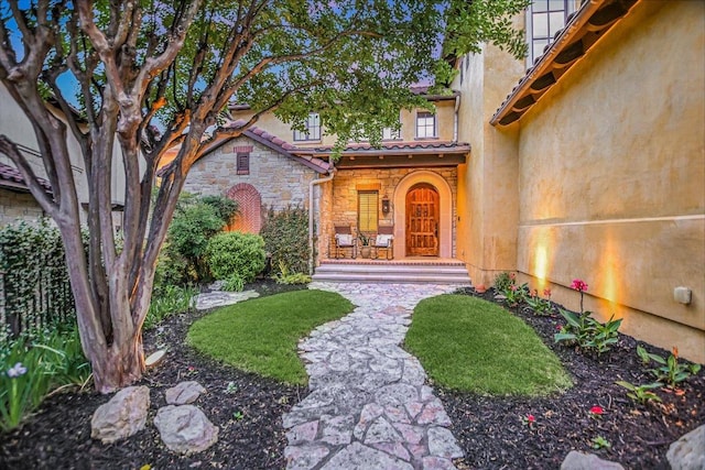 5525 City Park Rd Unit 6, Austin, TX 78730 - view of exterior entry featuring stone siding, stucco siding, and a tile roof