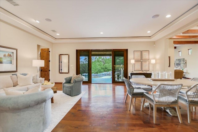 living room featuring visible vents, recessed lighting, a raised ceiling, and wood finished floors