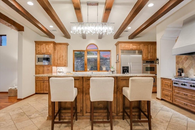5525 City Park Rd Unit 6, Austin, TX 78730 - kitchen with built in appliances, beamed ceiling, custom exhaust hood, backsplash, and a breakfast bar area