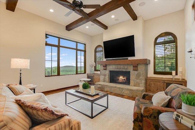 5525 City Park Rd Unit 6, Austin, TX 78730 - living room with wood finished floors, beam ceiling, healthy amount of natural light, ceiling fan, and a stone fireplace