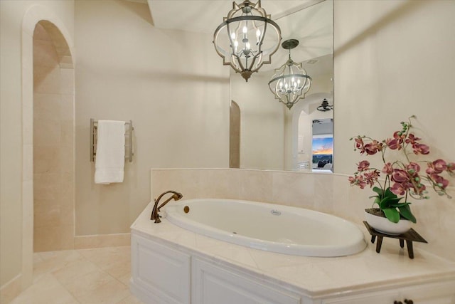 full bathroom with an inviting chandelier and a bath