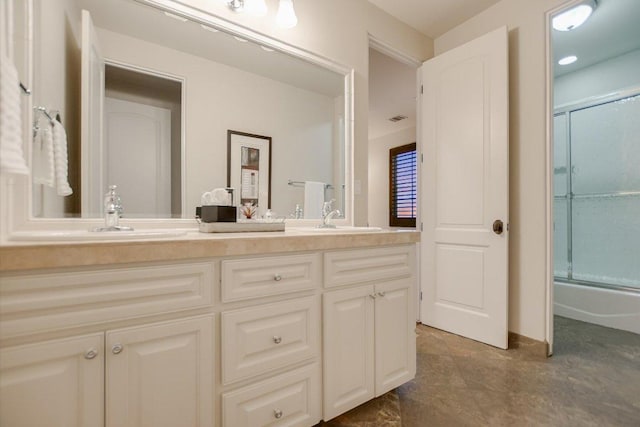 bathroom featuring double vanity, visible vents, and a sink