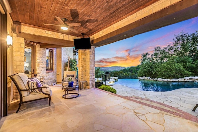 view of patio with a fenced in pool and a ceiling fan