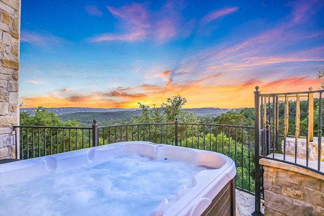 5525 City Park Rd Unit 6, Austin, TX 78730 - balcony at dusk with a hot tub and a mountain view