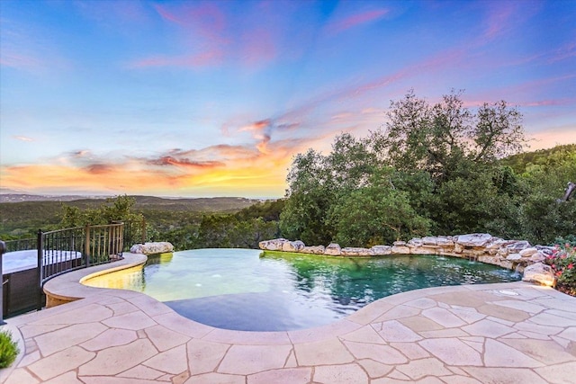 5525 City Park Rd Unit 6, Austin, TX 78730 - pool at dusk featuring an outdoor pool