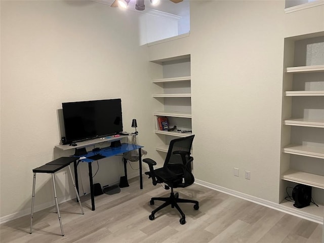 home office with a ceiling fan, baseboards, and wood finished floors