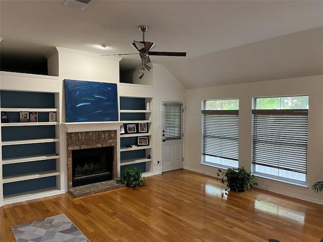 1728 Dapplegrey Ln, Austin, TX 78727 - unfurnished living room with ceiling fan, built in features, wood finished floors, vaulted ceiling, and a fireplace