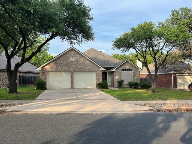 single story home featuring a garage, a front lawn, fence, brick siding, and driveway