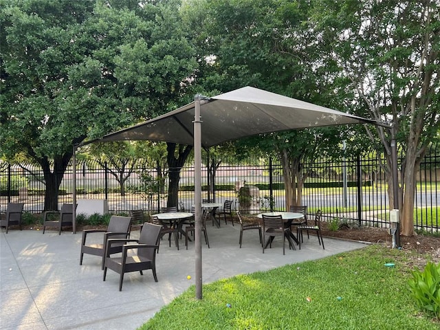 surrounding community featuring fence and a patio area