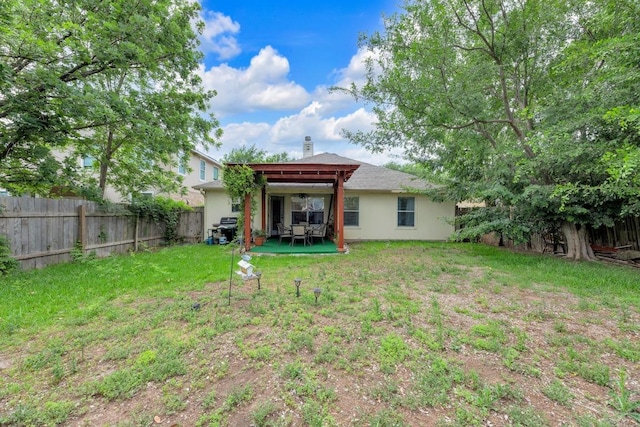 rear view of property with a lawn, a fenced backyard, and a patio area