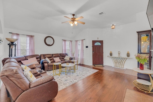 living room with ceiling fan, a healthy amount of sunlight, lofted ceiling, and wood finished floors