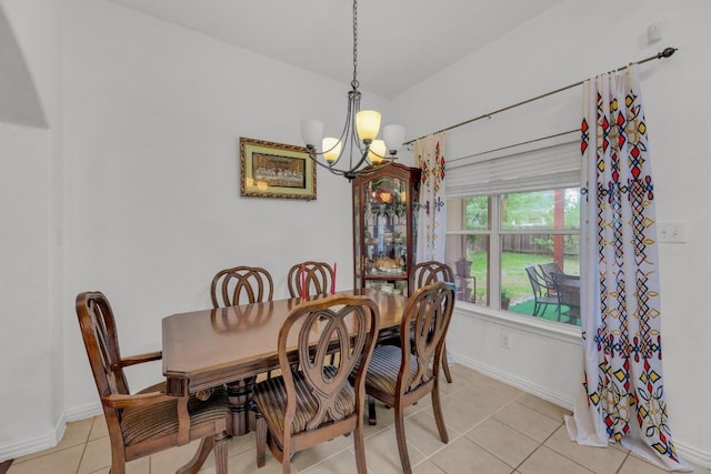 dining area with baseboards, a chandelier, and light tile patterned floors