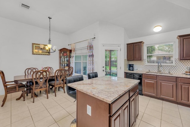 kitchen with black dishwasher, light tile patterned floors, a chandelier, a sink, and backsplash