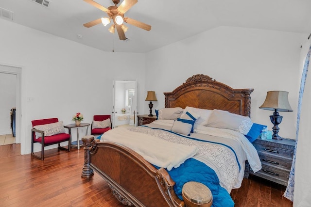 bedroom featuring visible vents, a ceiling fan, lofted ceiling, and wood finished floors