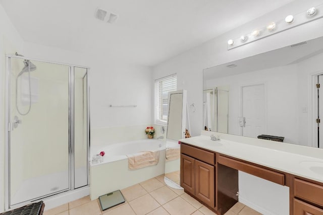 full bath with a sink, double vanity, a shower stall, and a garden tub
