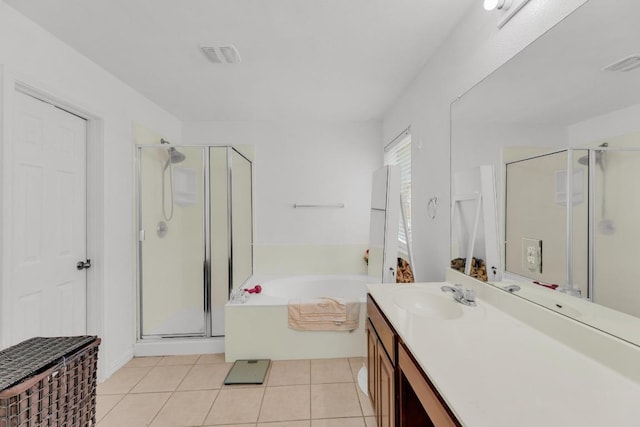 bathroom with tile patterned flooring, a shower stall, a bath, and vanity