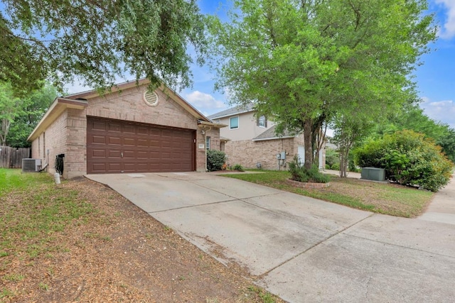 single story home featuring central air condition unit, driveway, brick siding, and a garage