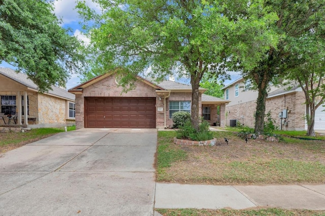 ranch-style house featuring concrete driveway, brick siding, central air condition unit, and a garage