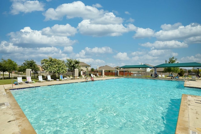 pool with fence and a patio area