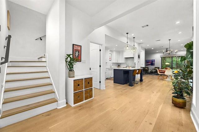 interior space featuring recessed lighting, stairway, visible vents, and light wood finished floors